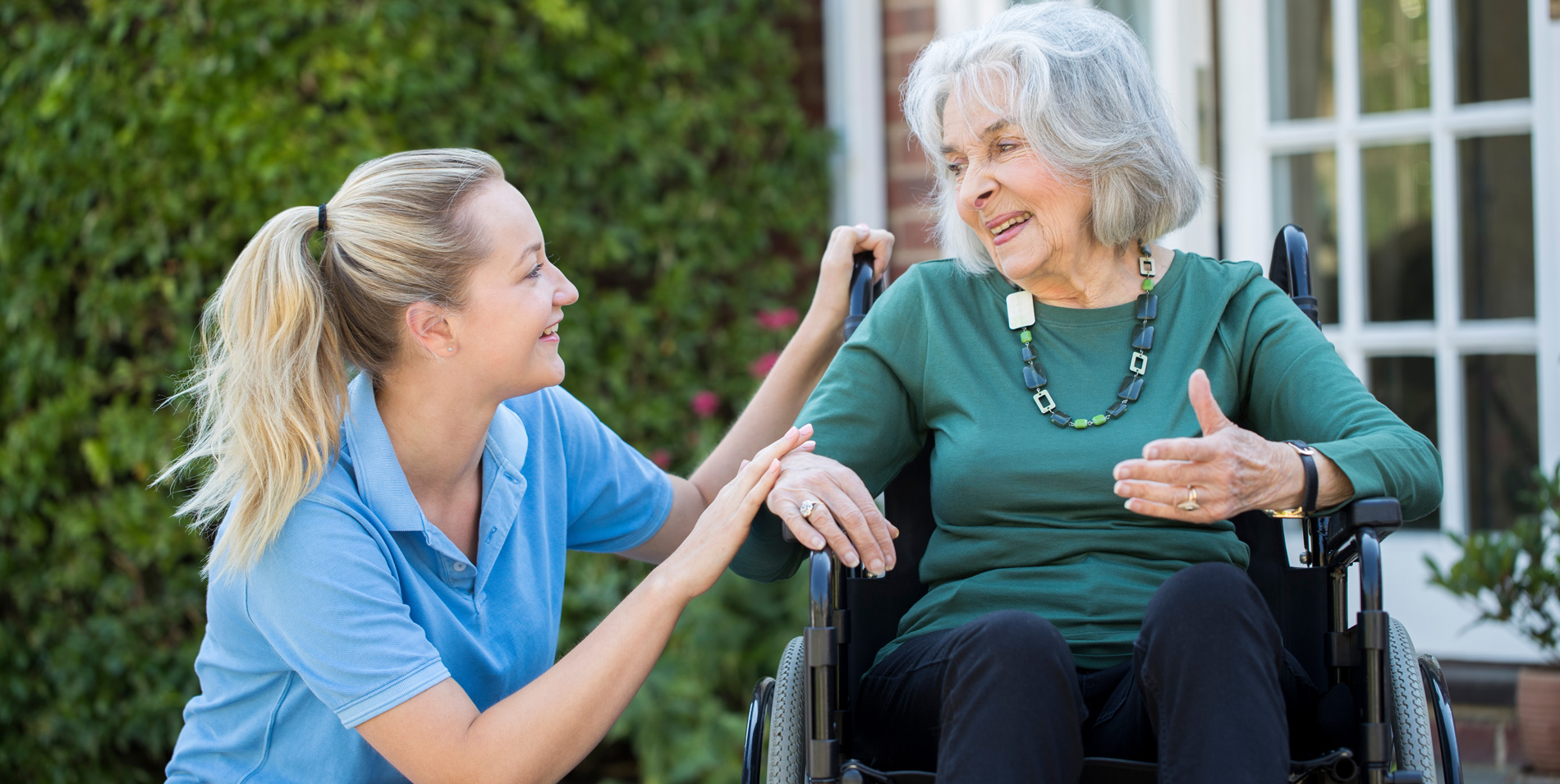 Group of three residents in conversation at a table, Life Care Gaynes Park Suites